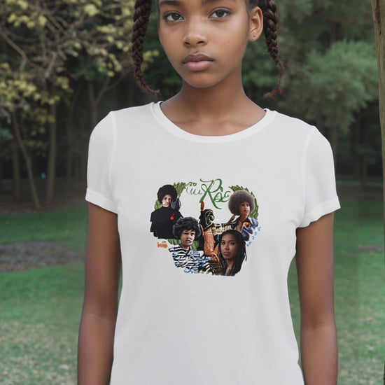 Woman standing strong in spiritual “May We Rise” tee made from sustainable fabric